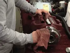 Vacuum repair technician cleaning and servicing a vacuum motor in Fort Wayne, IN